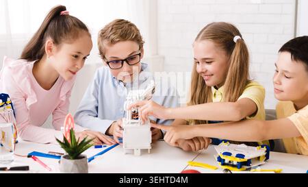 Children Engaged in Creative Building Activity Together in a Bright, Modern Setting Stock Photo