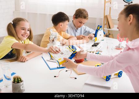 Children Engaged in Robotics Workshop While Learning and Collaborating on Projects Stock Photo