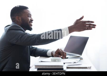Friendly HR manager extending hand for handshake after successful interview Stock Photo