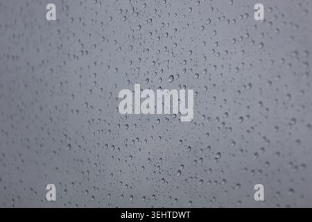 Close up of rain drops on window glass in bad weather Stock Photo