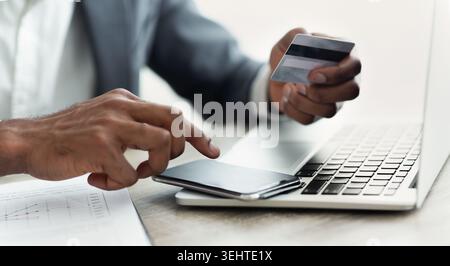 Online Payment Process With Credit Card and Smartphone at a Modern Workspace Stock Photo