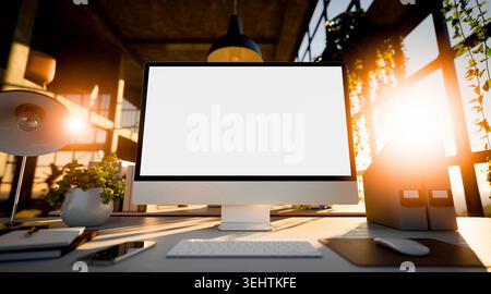 Computer blank screen mockup in a modern sunlit office workspace with green plants, desk accessories, and window light, close-up front view. Stock Photo