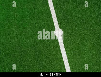 the green grass on the line in soccer stadium. Close up midfield with center point. Stock Photo