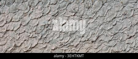 Close-up of grey cement wall with a decorative, highly textured finish. Stock Photo