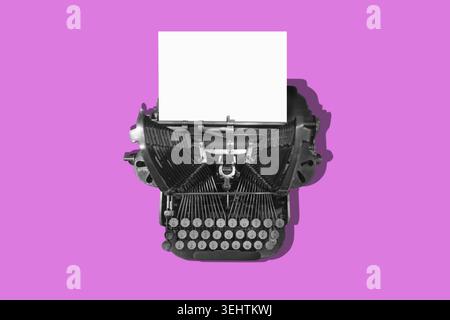 Pink vintage typewriter with a white sheet of paper. Concept for writing and sending a message. Stock Photo