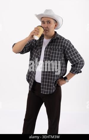Young handsome man in cowboy hat looking away thoughtfully in studio Stock Photo