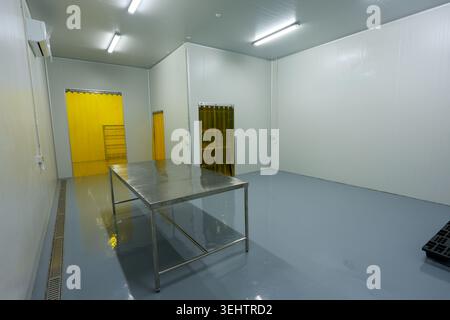 Empty clean sterile laboratory white room with stainless steel table feeling cold calm and industrial ready for medical research or food processing fa Stock Photo