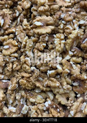 Walnut halves closely packed creating a textured natural background for healthy food concepts. Mobile photo Stock Photo