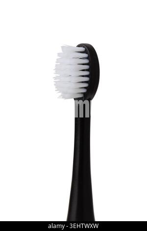 Toothbrush head showing white bristles on a black handle for oral care isolated on a white background Stock Photo