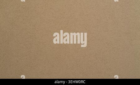Seamless light brown rough stucco wall texture, blank grainy sand plaster background surface. Stock Photo
