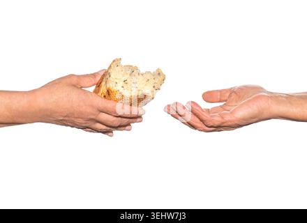 Pieces of bread. Helping the homeless. Elder woman hand give a loaf of bread to hands of a beggar. Poverty and world hunger concept Stock Photo
