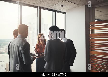 Happy, business people or meeting with team in boardroom for project planning or strategy. Group, employees or colleagues talking with smile for Stock Photo
