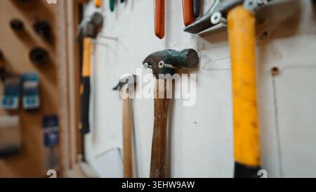 Hand tools hanging, showing hammers in a wood crafting workshop Stock Photo