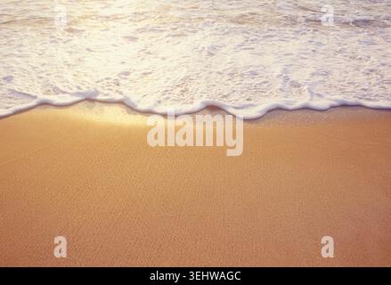 Close-up of sea wave washing sandy beach Stock Photo