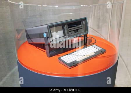 Rotterdam, Netherlands - 16 May 2026. A classic vintage Commodore SX-64 portable computer with keyboard on display inside a protective transparent cas Stock Photo