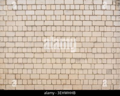 Old white brick wall texture background. Silicate brick blocks wall bg, ancient bricks fence, retro stonewall with copy space, grey brickwork exterior Stock Photo