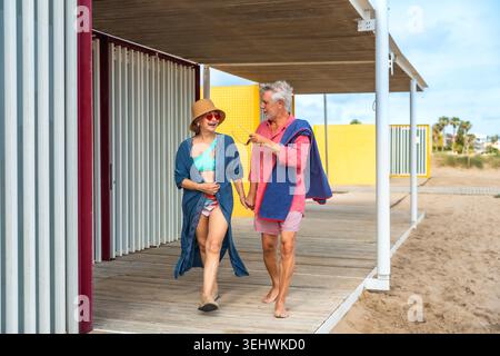 Senior couple enjoying beach walk holding hands Stock Photo