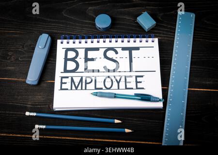 Best Employee Words Written on Spiral Notebook With Stationery Stock Photo