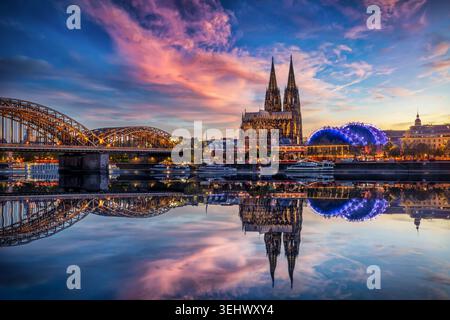 Beautiful view of the illuminated Cathedral in Cologne, Germany, just after sunset with reflections in the river Rhine Stock Photo