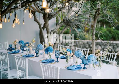 Elegant outdoor celebration. Romantic garden wedding with lighting and floral decorations Stock Photo