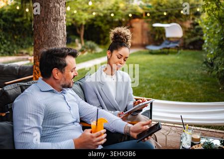 Business partners collaborating outdoors discussing project ideas Stock Photo