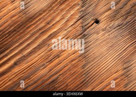 Nail hole in old wood textured background. Dark driftwood surface, burnt wood brushing, macro vintage brown floor, grain oak timber desk close up, rus Stock Photo