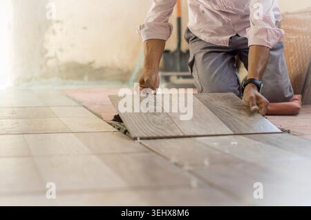 Worker installing a ceramic floor Stock Photo