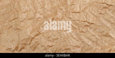 Crumpled Craft Paper Top View with Copy Space for Collages, Design and Montage. Empty Wrinkled Sheet of Brown Wrapping Old Paper Texture with Place fo Stock Photo