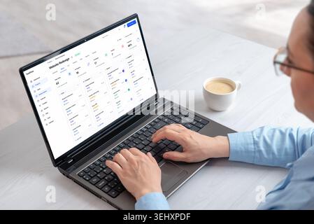 Project management dashboard displayed on laptop during remote workflow session, featuring task organization, planning tools and productivity analytic Stock Photo