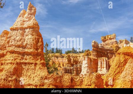 Bryce canyon national park canyon showcasing towering orange hoodoos carved from ancient layered rock, standing out against a clear blue sky with dist Stock Photo