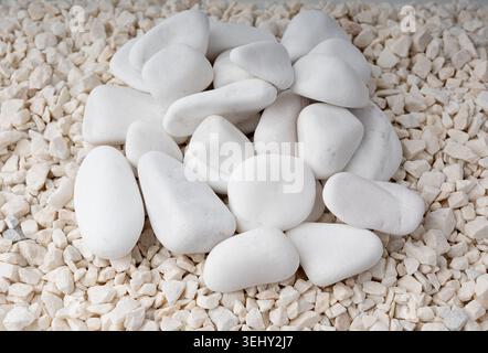 Crushed quartzite pebble textured background, white decorative marble stones close up. Small gravel pattern, natural white limestone for garden decora Stock Photo
