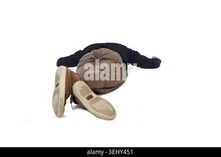 a man lying face down on the floor with his legs intertwined Stock Photo