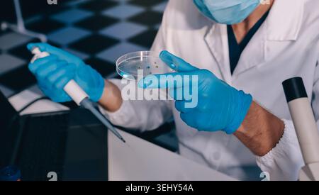 Lab technician experimenting in lab Stock Photo