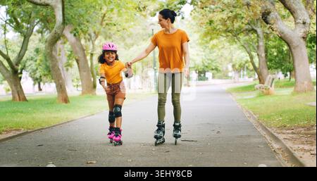 Roller skating, holding hands and mother with child in nature on holiday, getaway or weekend trip with balance. Happy, safety and mom with kid in Stock Photo