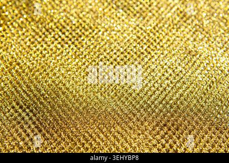 Close-up gold glitter texture background with sparkling metallic pattern and luxury feel Stock Photo
