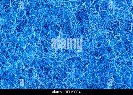 Full frame view of bright blue chaotic synthetic fibers, macro tangled texture background Stock Photo