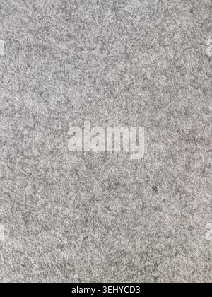 Grey felt fabric showing soft smooth textile texture, offering a warm and insulating material background for design, craft projects Stock Photo