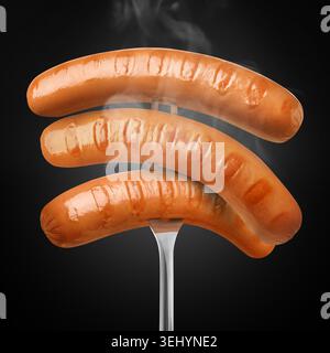 Hot grilled meat sausages on fork against black gradient background Stock Photo