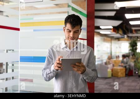 Middle Eastern businessman using digital tablet in coworking office Stock Photo