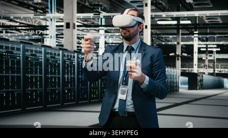 Data center computer scientist uses VR headset tech to visualize and debug system errors. Server farm worker uses virtual reality simulation to run diagnostics on wireframe mesh gear, camera A Stock Photo
