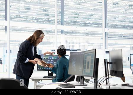 Hardware developer in microchip production fab office using machine learning to conduct RD study on SoC architecture design. Computer scientist develops cutting edge semiconductors technology using AI Stock Photo