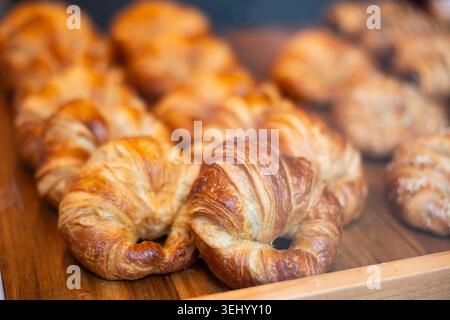 Fresh croissants on a shelf in the store Stock Photo