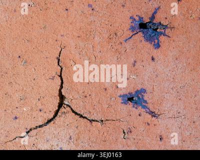 Cracks and marks on rustic clay floor tiles forming abstract shapes, macro photography captured in the terrace of a farm in the eastern Andes Stock Photo