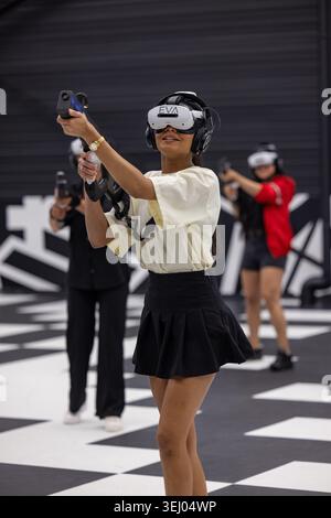 Wittenheim, France - 23 May 2026: View of people playing virtual reality esports at EVA Mulhouse, wearing headsets and holding motion controllers on a Stock Photo