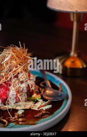 wonton cracker with fresh tuna cubes and fried onions with celery and garlic cream. Stock Photo