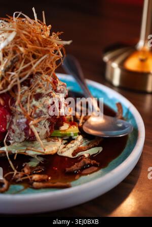 wonton cracker with fresh tuna cubes and fried onions with celery and garlic cream. Stock Photo