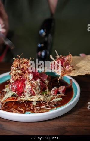 wonton cracker with fresh tuna cubes and fried onions with celery and garlic cream. Stock Photo