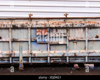 Heavy-duty steel formwork panels and modular molds stacked in an industrial yard. These weathered metal structures are used for precast concrete wall Stock Photo