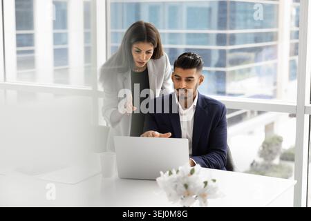 Teammates discussing project strategy in modern office Stock Photo