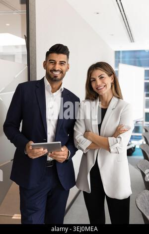 Two confident business professionals standing in modern office Stock Photo